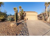 Inviting home featuring drought-tolerant landscaping, a paved driveway, and an attached two car garage at 3055 N Red Mtn # 178, Mesa, AZ 85207