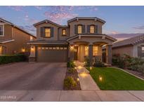 Charming two-story home with landscaped yard, lighting, covered porch, and two-car garage at 3483 W Verde River Rd, San Tan Valley, AZ 85144