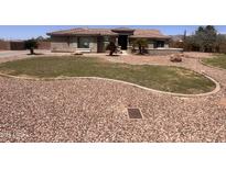 Charming single-story home with desert landscaping and a circular driveway provides plenty of curb appeal at 3608 N Mansfield Dr, Litchfield Park, AZ 85340