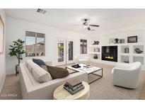 Bright living room with a cozy fireplace, built-in shelves, and plenty of natural light at 3792 E Westchester Dr, Chandler, AZ 85249