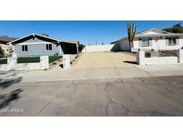 Charming home showcasing a low white fence and desert landscaping for low maintenance appeal at 4836 W Redfield Rd, Glendale, AZ 85306