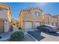 Charming two-story townhome with a two-car garage and a well-maintained front yard at 525 N Miller Rd # 122, Scottsdale, AZ 85257