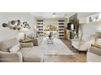 Inviting living room featuring neutral decor, a fireplace, and a sliding glass door to the outdoor space at 8653 E Royal Palm Rd # 1033, Scottsdale, AZ 85258