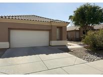 A well-maintained home with a two-car garage and desert landscaping at 901 W Oriole Way, Chandler, AZ 85286