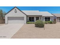 Charming single-story home with a well-maintained lawn and an attached two-car garage at 1016 E Utopia Rd, Phoenix, AZ 85024