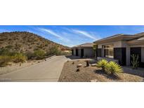Desert home featuring a multi-car garage, low maintenance landscaping, and mountain views at 12276 N 129Th St, Scottsdale, AZ 85259