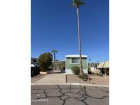 Charming exterior of a one-story home with a carport, easy access parking, and green accents at 12814 N 19Th Pl # 19, Phoenix, AZ 85022
