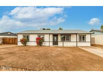 Charming single-story home with a minimalist desert landscape and a covered entry way at 14436 N 34Th Pl, Phoenix, AZ 85032