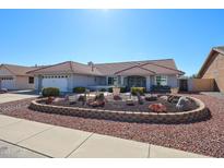 Charming single-story home featuring a well-maintained desert-style front yard and a red tile roof at 14909 W Alpaca Dr, Sun City West, AZ 85375