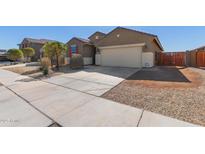 Charming one-story home features a two car garage, desert landscaping, and a cozy front porch at 17583 W Paraiso Dr, Surprise, AZ 85387