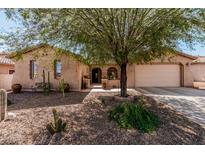 Charming single-story home featuring desert landscaping, covered entry, and a two-car garage at 19405 W Oregon Ave, Litchfield Park, AZ 85340