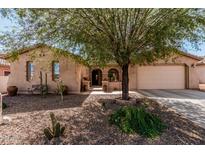 Charming single-story home featuring desert landscaping, covered entry, and a two-car garage at 19405 W Oregon Ave, Litchfield Park, AZ 85340
