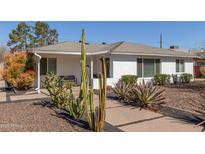 Charming home with desert landscaping featuring saguaro cacti and a lush bush at 2902 E Avalon Dr, Phoenix, AZ 85016