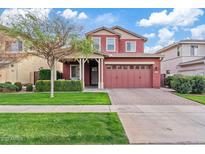 Charming two-story home featuring a covered porch, green lawn, and brick driveway at 3117 E Sagebrush St, Gilbert, AZ 85296