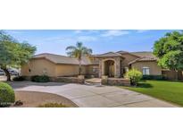 Charming single-story home featuring a lush front yard, desert landscaping, and a grand entrance at 4815 W Desert Hollow Dr, Phoenix, AZ 85083