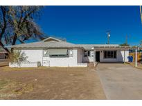 Charming single-story white home featuring a covered parking area and a well-lit entrance at 638 W 16Th St, Tempe, AZ 85281