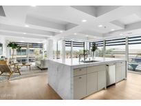 Modern open kitchen featuring a large island, stainless steel appliances, and an abundance of natural light and light-colored cabinets at 7137 E Rancho Vista Dr # 5001, Scottsdale, AZ 85251