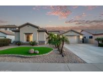 Charming single-story home featuring desert landscaping, an artificial turf accent and a two-car garage at 7223 W Saddlehorn Rd, Peoria, AZ 85383