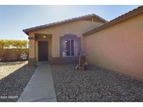 Charming single-story home featuring a cozy front porch, rock landscaping, and neutral color scheme at 8735 W Royal Palm Rd, Peoria, AZ 85345