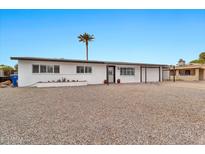 Charming single-story home featuring a desert landscape, covered parking, and a well-maintained front yard at 934 S Roslyn Pl, Mesa, AZ 85208