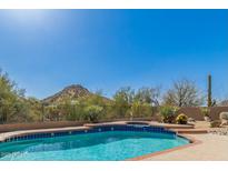 Inviting pool area with mountain views, desert landscaping and clear blue water at 11743 E Desert Vista Dr, Scottsdale, AZ 85255