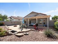 A delightful backyard featuring a covered patio and outdoor dining area, perfect for entertaining at 15876 W Alpine Ridge Dr, Surprise, AZ 85374