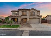 Charming two-story home with a well-maintained lawn and a two-car garage at sunset at 1835 E Bartlett Pl, Chandler, AZ 85249