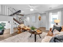 Inviting living room featuring a plush rug, modern decor, and staircase access at 2 W Georgia Ave # 5, Phoenix, AZ 85013