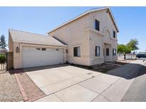 Charming two-story home featuring an attached two-car garage and a concrete driveway at 2051 W Ronald Rd, Phoenix, AZ 85029