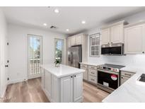 Bright kitchen featuring stainless steel appliances, white cabinets, and a center island with quartz countertops at 2789 S Balsam Dr, Gilbert, AZ 85295