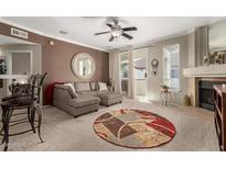 Comfortable living room with fireplace, neutral carpet, slider and stylish sectional sofa at 2992 N Miller Rd # 219B, Scottsdale, AZ 85251