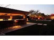 Outdoor oasis with a bar, fire pit, and ample seating for entertainment in backyard at 31626 N 129Th Dr, Peoria, AZ 85383