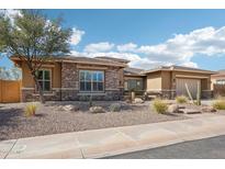 Charming home featuring desert landscaping, stone accents, and a two-car garage at 31626 N 129Th Dr, Peoria, AZ 85383