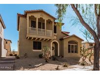 Charming two-story home featuring a quaint balcony and a well-manicured desert landscape at 32405 N 23Rd Ave, Phoenix, AZ 85085