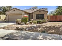 Charming single-story home with desert landscaping, two-car garage, and a lovely tiled roof at 3417 N 131St Ln, Litchfield Park, AZ 85340