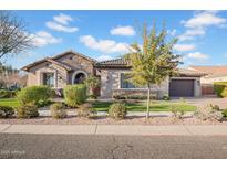 Charming single-story home with stone accents, a well-manicured lawn and a nicely landscaped yard at 346 W Alamosa Dr, Chandler, AZ 85248