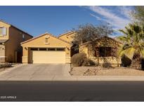 Charming single-Gathering home with a two-car garage, desert landscaping, and a welcoming facade at 41250 W Thornberry Ln, Maricopa, AZ 85138