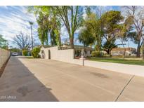 Spacious driveway and lush landscaping surround this charming home in a quiet neighborhood at 430 N Vineyard --, Mesa, AZ 85201