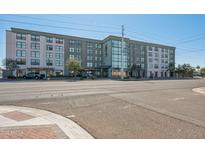 Modern apartment building facade with street view and businesses on the ground floor at 535 W Thomas Rd # 207, Phoenix, AZ 85013