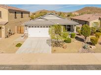 Charming single-story home with a two-car garage, desert landscaping, and a mountain backdrop at 538 E Pasaro Dr, Phoenix, AZ 85085