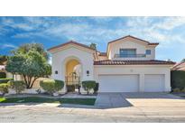 Elegant two-story home featuring arched entry, tile roof, and a two-car garage at 7667 E Krall St, Scottsdale, AZ 85250