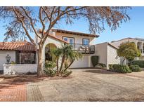 Stunning two-story home featuring a red tile roof, balcony, two car garage, and beautifully landscaped yard at 77 E Missouri Ave # 7, Phoenix, AZ 85012