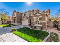 Charming two-story home with a well-manicured lawn and a two-car garage on a sunny day at 1421 E Hopkins Rd, Gilbert, AZ 85295