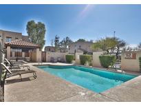 Inviting community pool with lounge chairs and shaded area for residents to relax and enjoy the outdoors at 1930 E Hayden Ln # 118, Tempe, AZ 85281