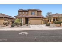 Two-story home featuring a tile roof, desert landscaping, and a two-car garage at 23619 W Harrison Dr, Buckeye, AZ 85326
