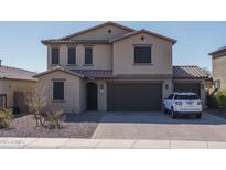 Charming two-story home featuring a tile roof, three-car garage, and desert landscaping at 25930 N Thornhill Dr, Peoria, AZ 85383