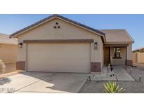 Inviting single-story home featuring a neutral palette and a two-car garage at 35711 W Costa Blanca Dr, Maricopa, AZ 85138