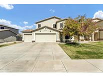 Charming two-story home with a well-manicured front yard, mature tree, and a spacious three-car garage at 4304 E Whitehall Dr, San Tan Valley, AZ 85140