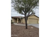 Charming single-story home with desert landscaping, a covered entryway and attached two-car garage at 5501 S Dove Crk Crk, Buckeye, AZ 85326