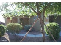 Charming single-story home featuring a well-maintained front yard with desert landscaping and a covered entryway at 5501 S Dove Crk Crk, Buckeye, AZ 85326
